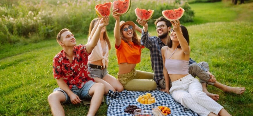 Group,Of,Friends,Having,Fun,Eating,Watermelon,On,The,Picnic